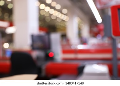Blurred view of checkout lanes in supermarket with bokeh effect