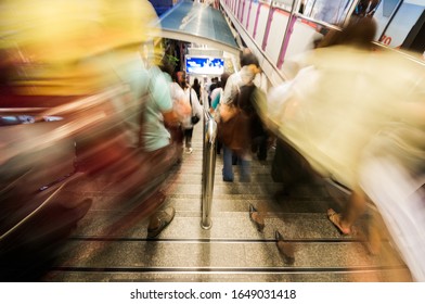 Blurred view of commuters walking down the Bangkok Skytrain to office, Thailand