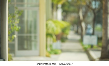 Blurred View Down Sunny Street With Small Office Building