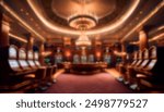 Blurred view of an elegant casino interior with luxurious chandeliers, slot machines, and a bar counter. The warm lighting creates a sophisticated and inviting atmosphere. Ideal for background use.