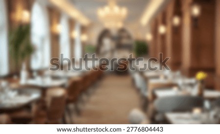 A blurred view of an elegant restaurant interior, showcasing tables, chairs, and a warm ambiance, perfect for dining and social gatherings. The image captures the essence of a sophisticated dining experience.