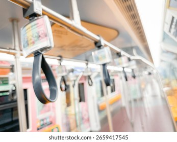 Blurred view of an empty subway train interior with bright yellow seats and stainless steel poles. The modern train car is well-lit, featuring overhead handles and smooth, clean floors
