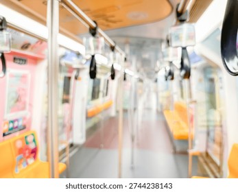 Blurred view of an empty subway train interior with bright yellow seats and stainless steel poles. The modern train car is well-lit, featuring overhead handles and smooth, clean floors, suggesting public transportation in motion.