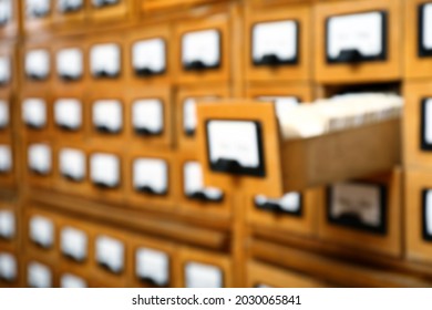 Blurred view of library card catalog drawers, space for text