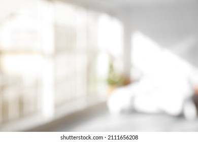Blurred view of light bedroom with big window - Shutterstock ID 2111656208