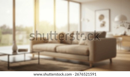 Blurred view of a light beige couch in a modern living room with large windows and natural light.