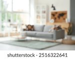 Blurred view of living room with sofa and world map near window