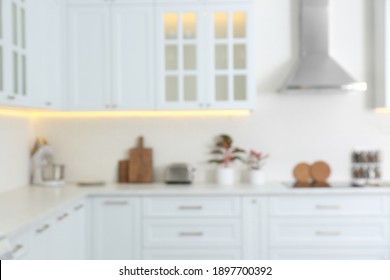 Blurred View Of Modern Kitchen With White Furniture