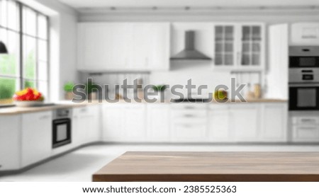 Blurred view of modern kitchen with white furniture with wooden table