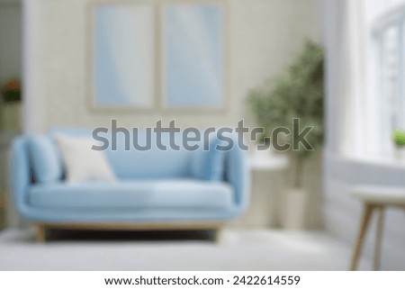 Blurred view of modern living room with sofa and soft bench. room interior with  couch, armchair and coffee table or shelving units. stylish living room. comfortable workplace near big window.