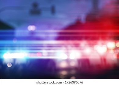 Blurred view of police cars on street at night - Shutterstock ID 1726396876