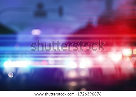 Blurred view of police cars on street at night