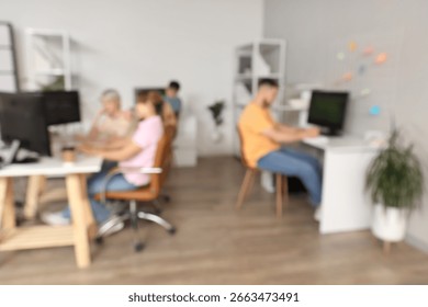 Blurred view of programmers working in office