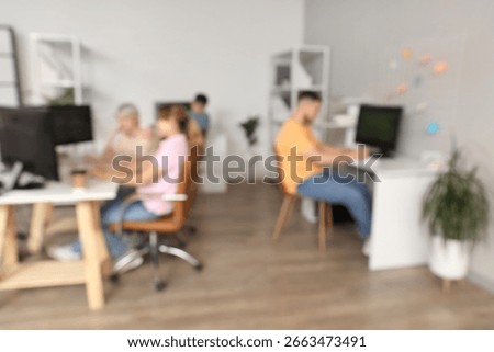 Blurred view of programmers working in office