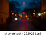 Blurred view of street with lights at winter rainy night. Bokeh lights background. Abstract artistic photography.