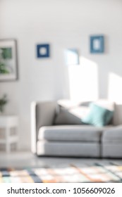 Blurred view of stylish living room interior with comfortable sofa