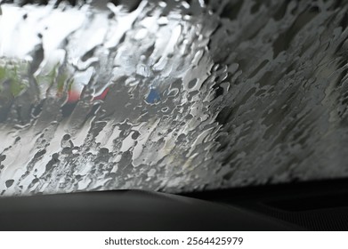 Blurred View Through Rain-Covered Windshield