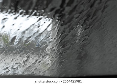Blurred View Through Rain-Covered Windshield