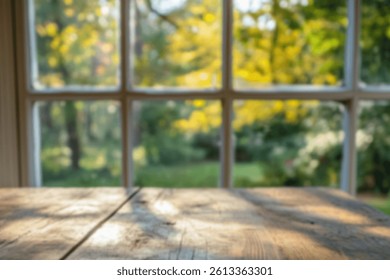 A blurred view through a window showcases an autumn landscape, with vibrant colors and natural light illuminating a wooden table.