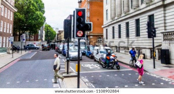 Blurred view of transport at one of tipical old\
english street. London.\
UK