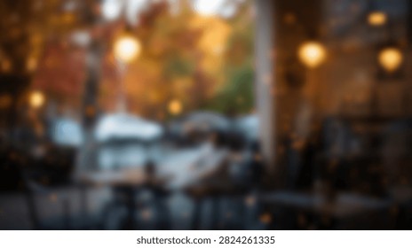 Blurred view of a warm and inviting cafe interior with soft glowing lights and colorful autumn leaves seen through the window.