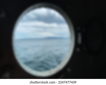 Blurred view from the window of the ferry boat sailing on the ocean during the day. - Shutterstock ID 2247477439