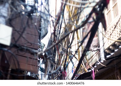blurred view of wire tangles in the old city of delhi. These messy wires are common as more and more households cropped up and many illegal connections were added to steal electricity