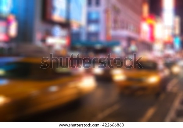 Blurred vision of 42nd Street in New York\
City, reflecting the ads, lights, crowds, taxis, traffic of cars\
and visitors in Times Square area in\
Manhattan.