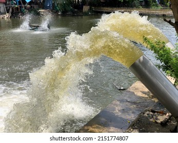 Blurred Water Spout From Pump Pipe To Canal After Heavy Rain In Thailand.Rain Water Pumping Out Through Water Pump Into Canal With Prevention For Flood.