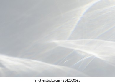 Blurred water texture overlay effect for photo and mockups. Organic drop diagonal shadow caustic effect with rainbow refraction of light on a white wall. Shadows for natural light effects - Shutterstock ID 2142000695