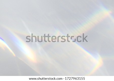 Blurred water texture overlay effect for photo and mockups. Organic drop diagonal shadow and light caustic effect on a white wall. Shadows for natural light effects