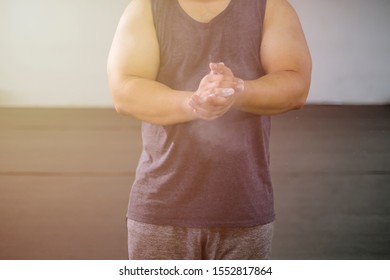 Blurred weightlifter clapping hands before barbell workout at the gym for background - Powered by Shutterstock