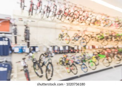 Blurred wide selection of bicycles at sporting goods chain store in USA. Various modern road, touring, cyclocross, mountain, commuter bikes with accessories and gears. Three tier sloping display rack - Powered by Shutterstock