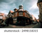 A blurred, wide-angle shot of a historic building in the UK with a bokeh effect.