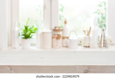 Blurred window sill with empty kitchen table top in front