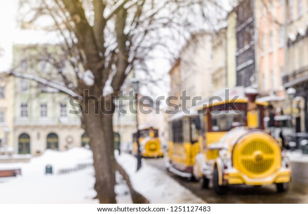Blurred winter\
background city tourist train tour excursion New Year faritale\
Christmas Miracle holiday mood atmosphere lifestyle blizzard cold\
falls snow panorama old\
city