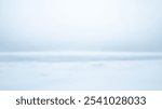 Blurred Winter Background of Blurred Winter Background of Serene Gray Snowfield Beneath Pale Sky