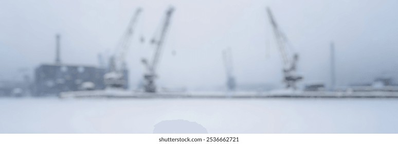 Blurred Winter Background of Blurred Winter Background of Snowy Construction Cranes Silhouetted in Winter Weather - Powered by Shutterstock