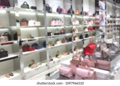Blurred woman fashionable accessory and bag brandname shop on department store