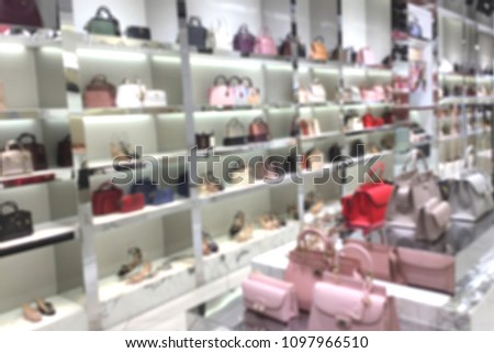 Blurred woman fashionable accessory and bag brandname shop on department store