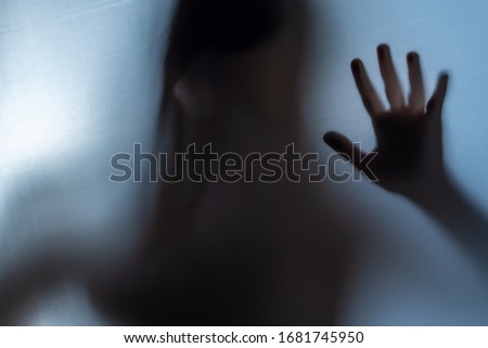 Blurred Woman's hand shadow asking for help. Horror and domestic violence concept.