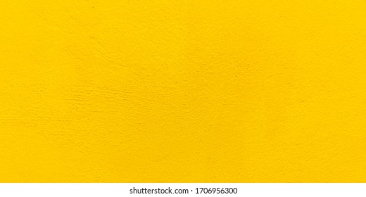 Blurred Yellow Stucco Wall Background. Yellow Painted Cement Wall Texture.