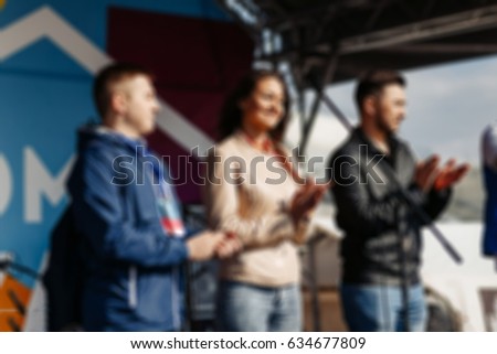 Similar – Multiethnic friends resting outside food truck in evening