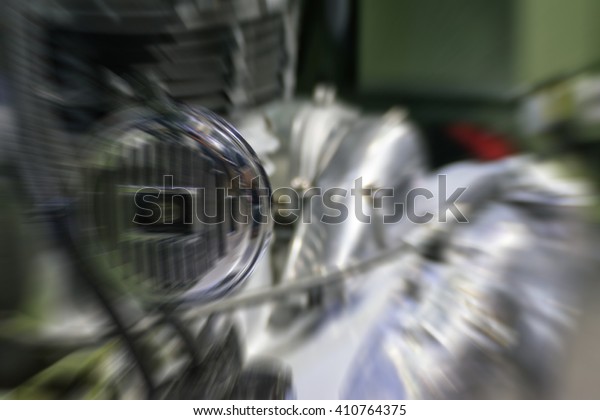 Blurred zoom of\
Some parts of the motorcycle in car show event. This a open event\
no need press credentials\
required.