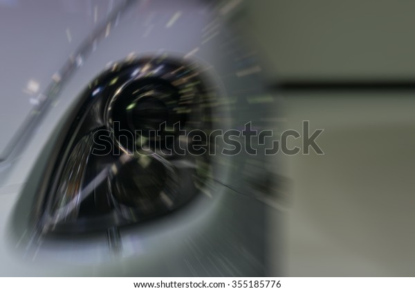 Blurred Zoom at sports car headlight in Car\
show event with light bokeh at Bangkok, Thailand. This a open event\
no need press credentials\
required.