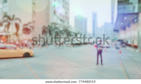 Blurred,People are walking across the street and\
the car is running along the\
lane.