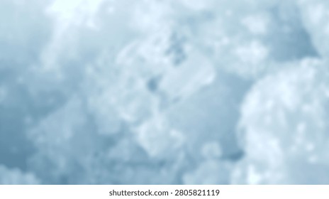A blurry abstract background featuring soft shades of blue and white resembling clouds or smoke