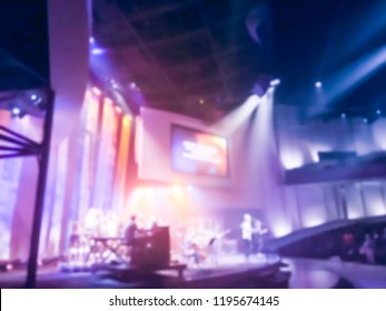 Blurry Abstract Worship Band And The Choir At Bible Church In Texas, USA. Dark Background, Smoke, Concert Spotlights For Christian Concept. Worship Lyric Projection