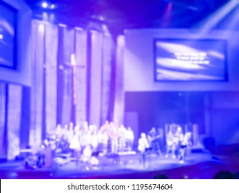 Blurry Abstract Worship Band And The Choir At Bible Church In Texas, USA. Dark Background, Smoke, Concert Spotlights For Christian Concept. Worship Lyric Projection