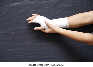 Blurry Of Arm Splint, Be In Plaster Cast.Injured Female Hand With Upper Part Of Body. Hand Is Bandaged With Plaster.